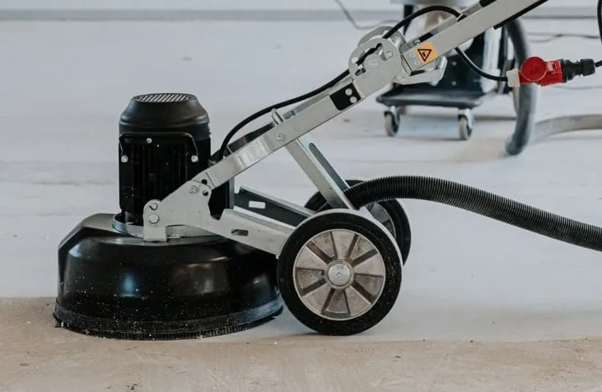 Professional contractor grinding a concrete floor